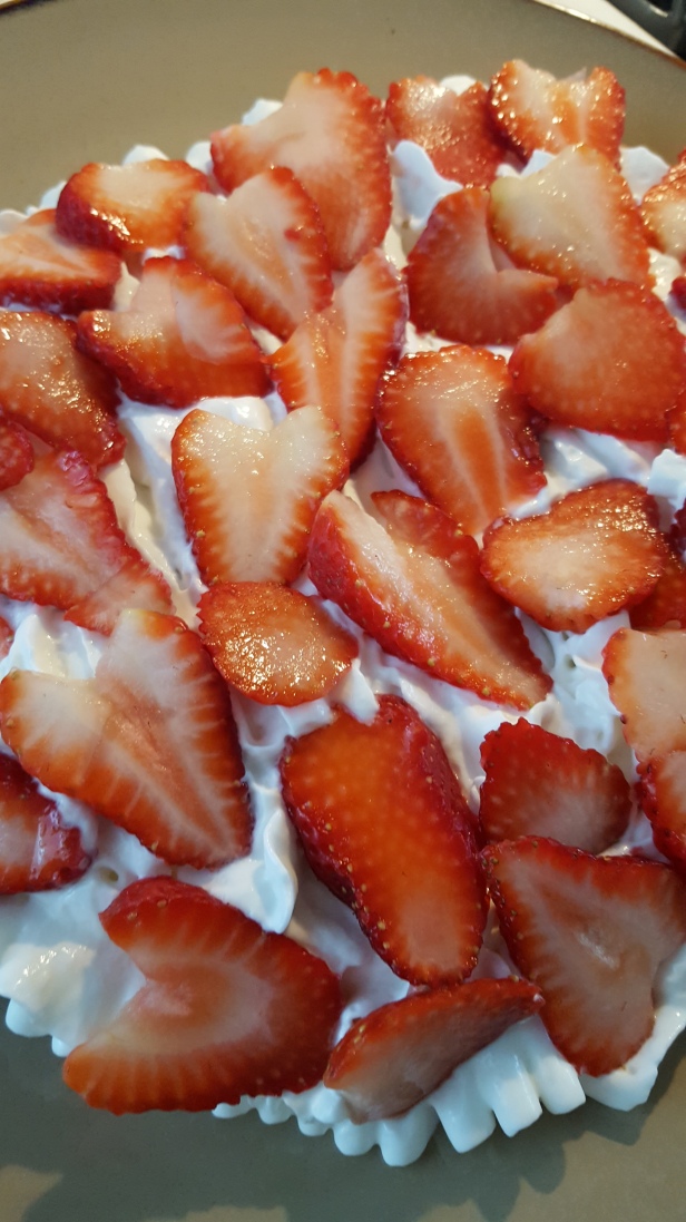 Crepes topped with whipped cream and strawberry
