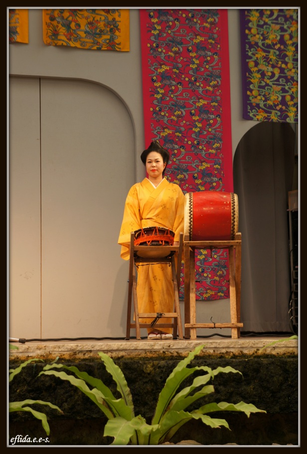 A female musical artist performing live at Ryukyu Mura in Okinawa, Japan.