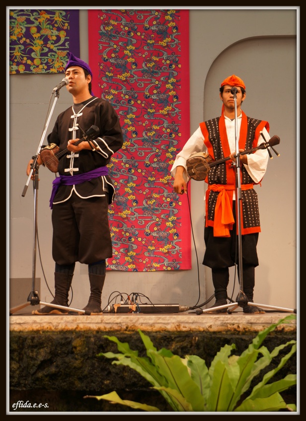 Male musical artists performing live at Ryukyu Mura in Okinawa, Japan.